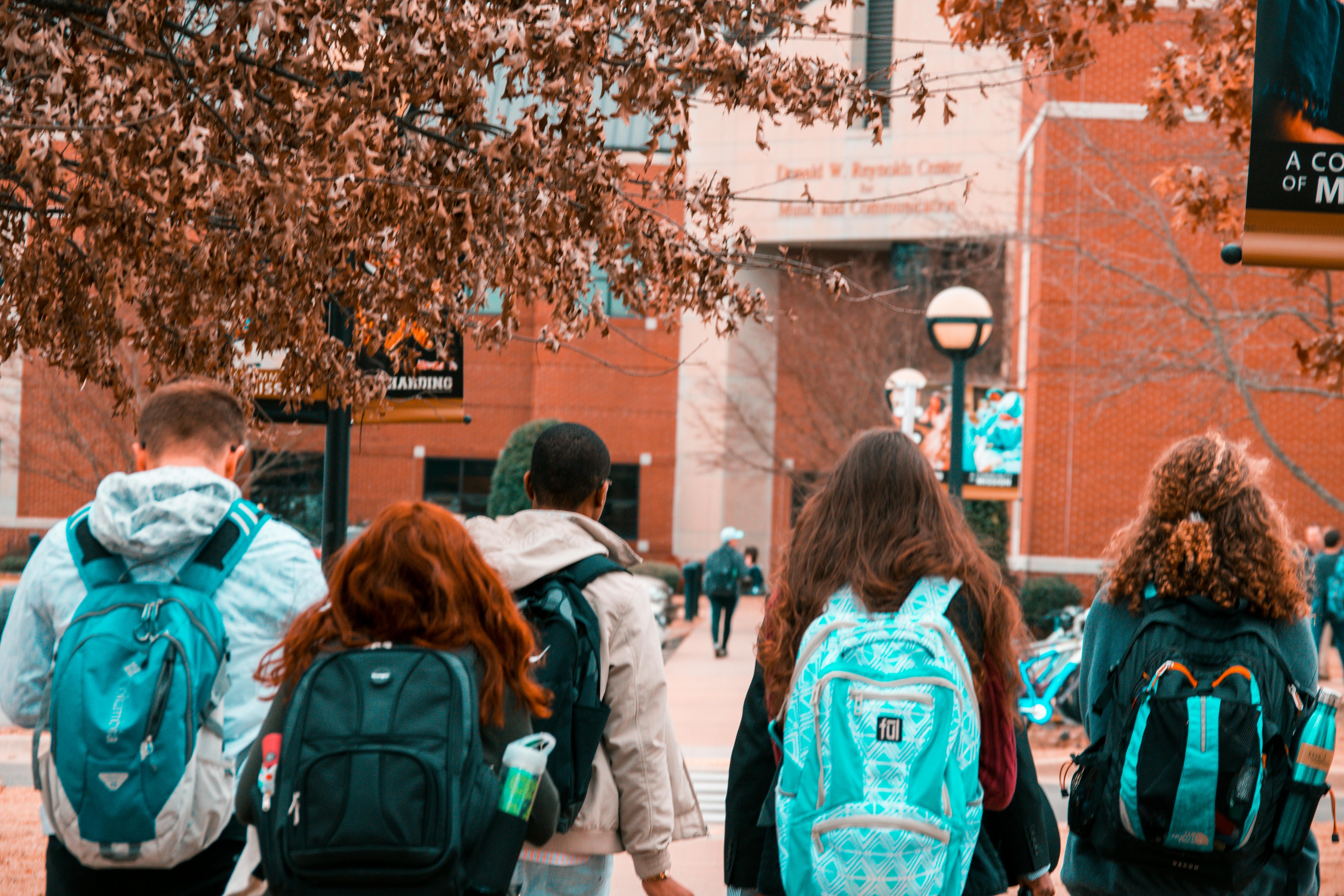 Four students with backpacks