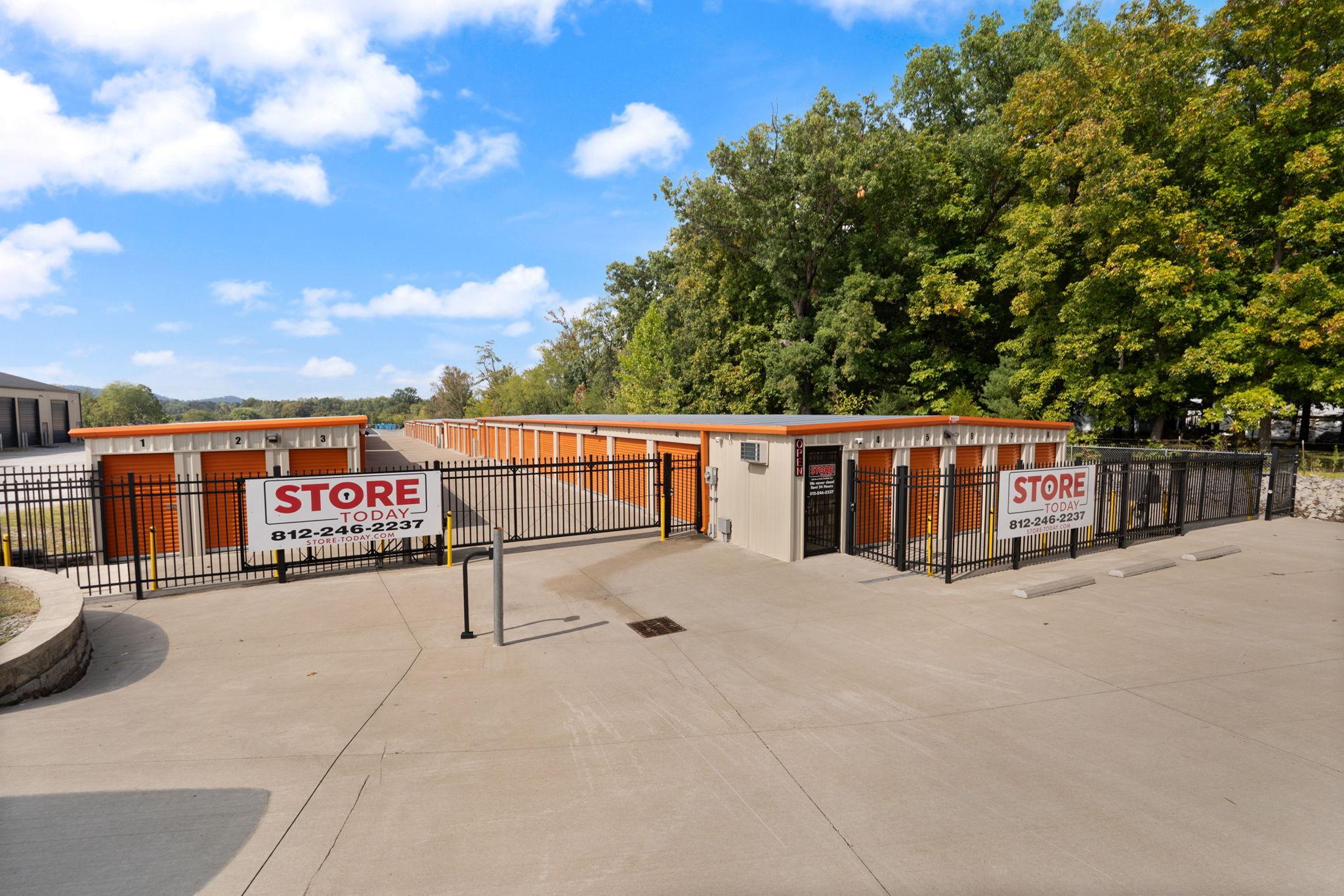 Entry to Store Today in Sellersburg, IN with drive up self storage units with orange doors