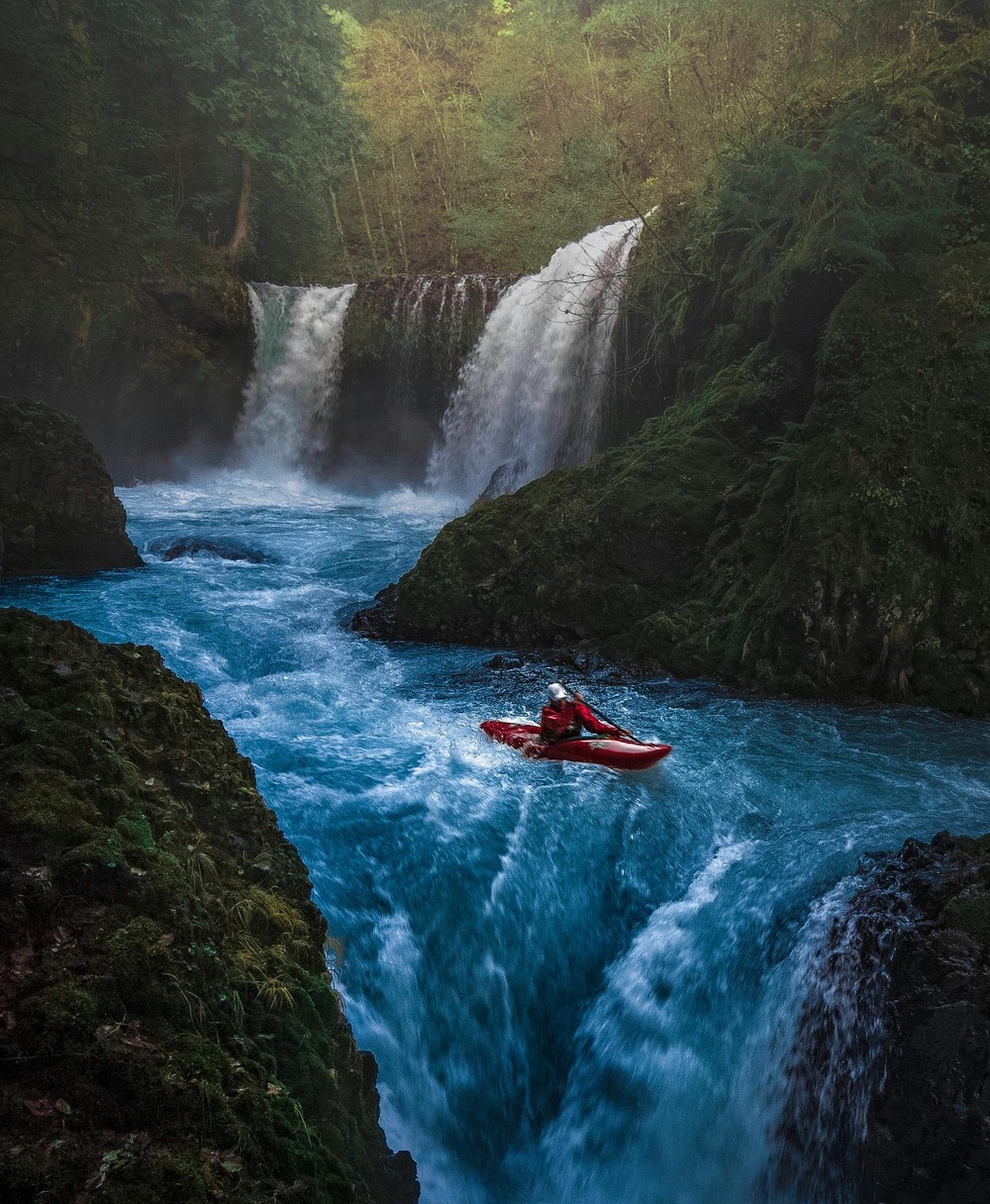 Kayak carrying a person going down a stream