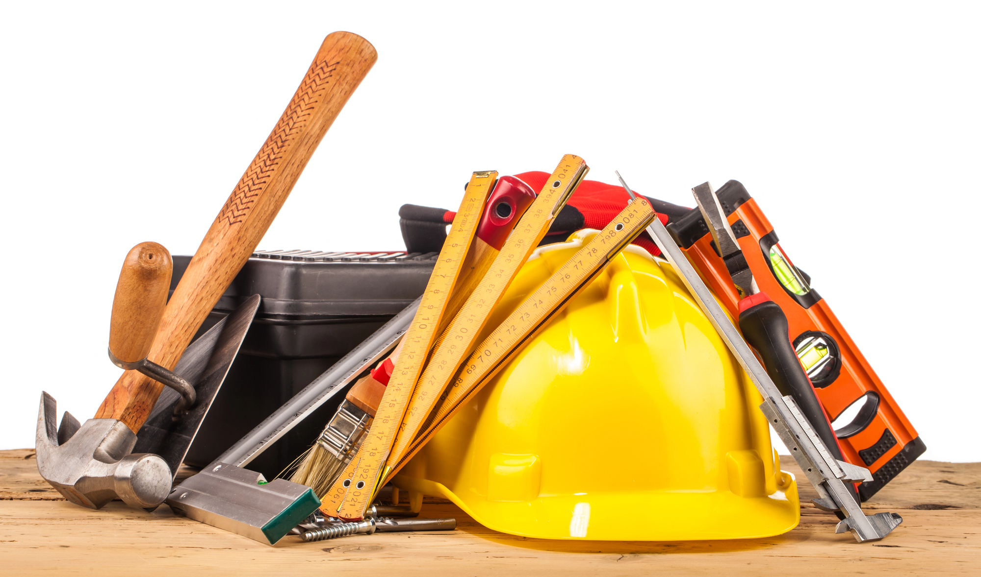 a pile of contractor tools on a wooden table a pile of contractor tools on a wooden table