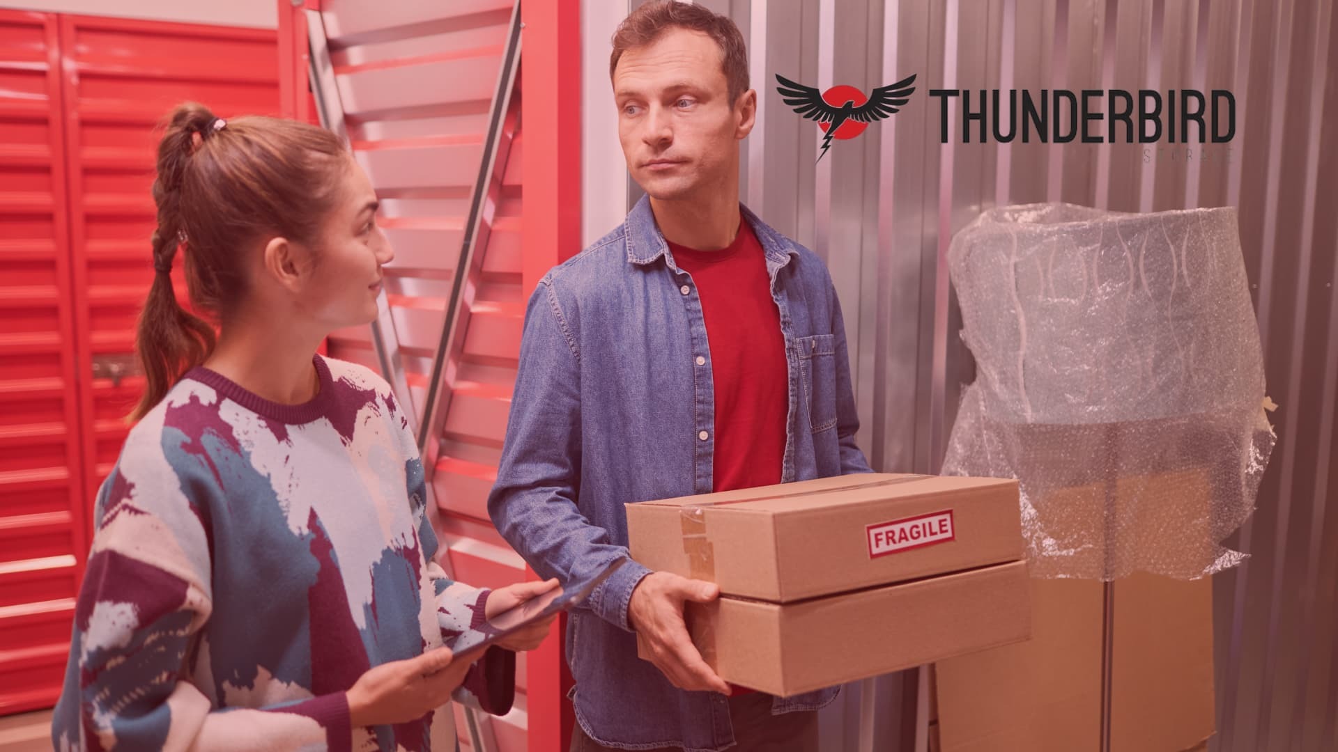 Couple deciding what to store first in Thunderbird self storage unit when preparing for a move