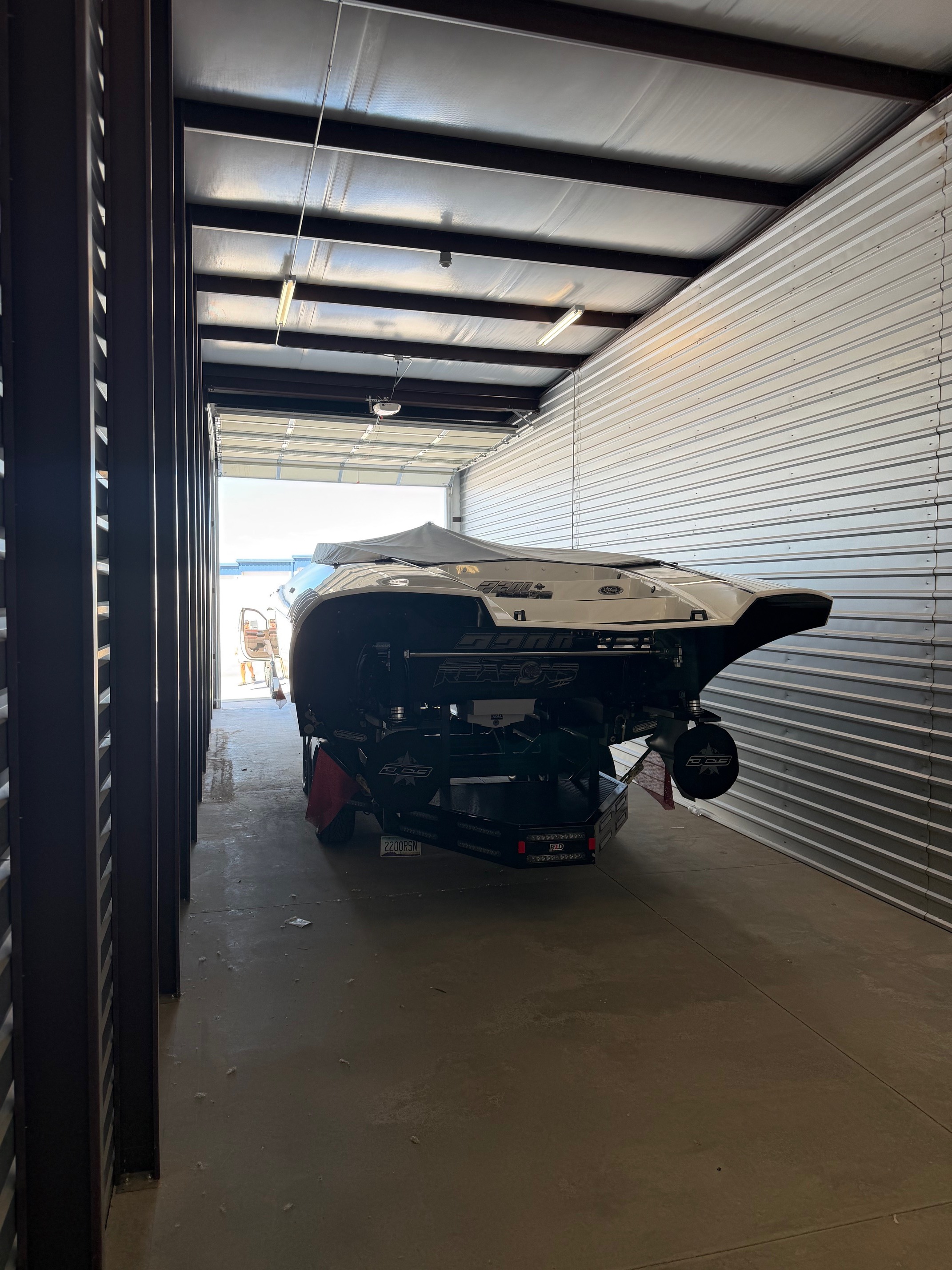 Interior view of a large custom boat parked safely inside an extra-deep, fully enclosed storage unit at High Octane Storage in Lake Havasu.