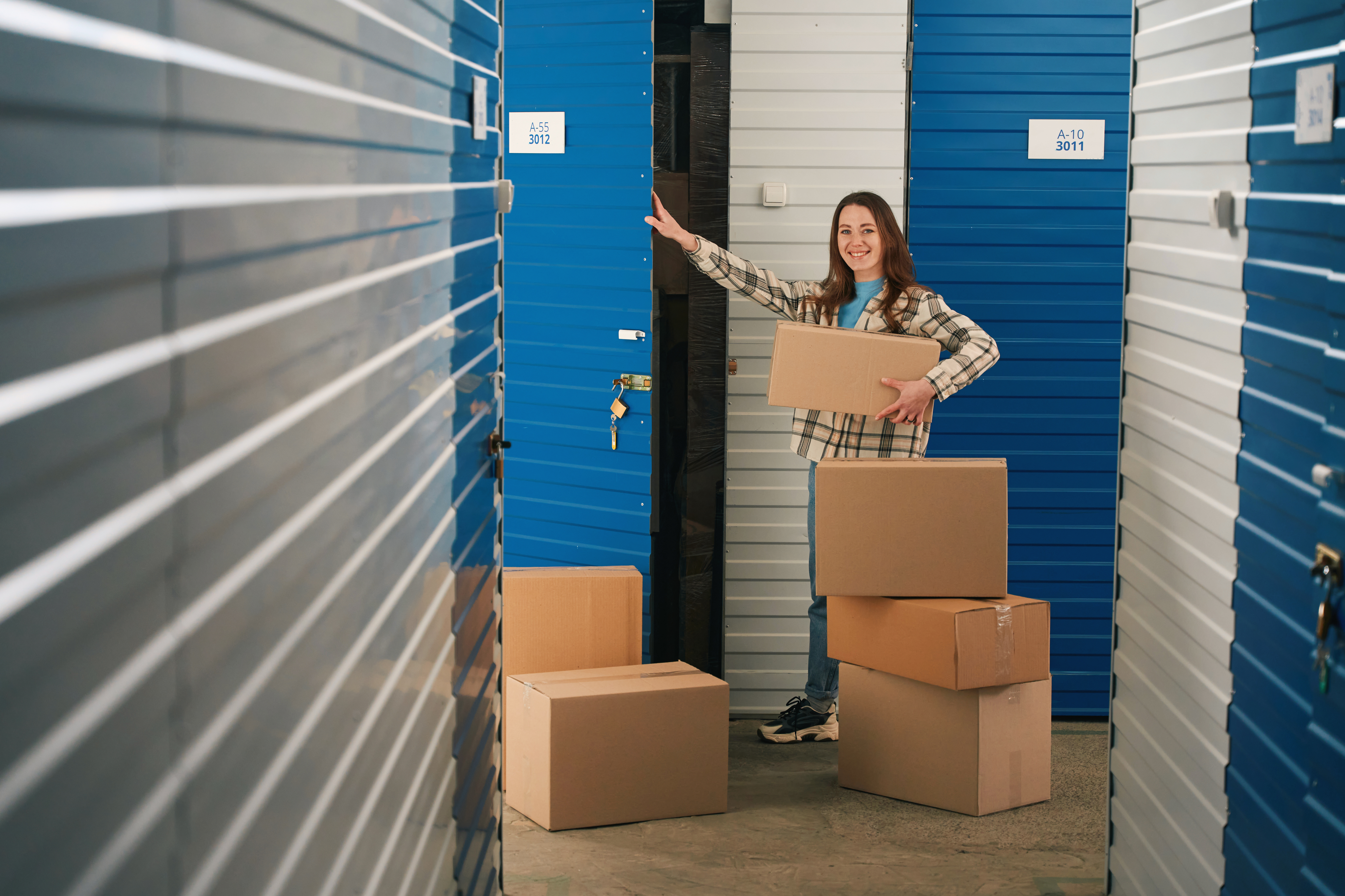 Woman moving boxes into a climate-controlled storage unit in Crown Point, IN. Woman moving boxes into a climate-controlled storage unit in Crown Point, IN.