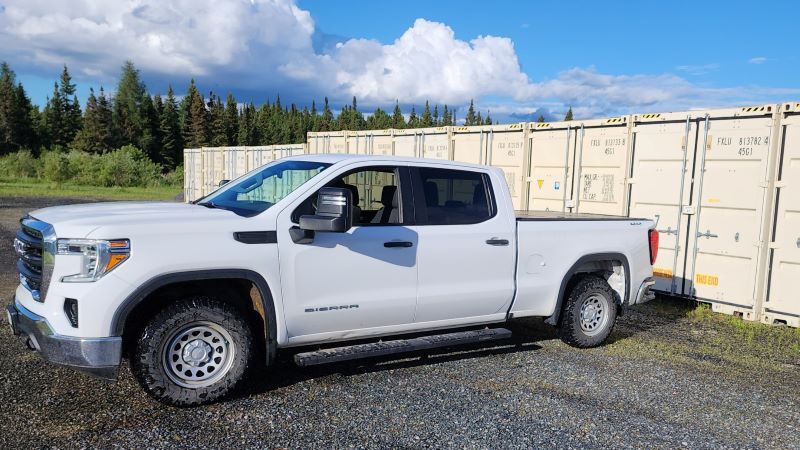 Pickup truck accessing secure drive-up self storage containers at DAM Reliable Storage in Kenora, Ontario.