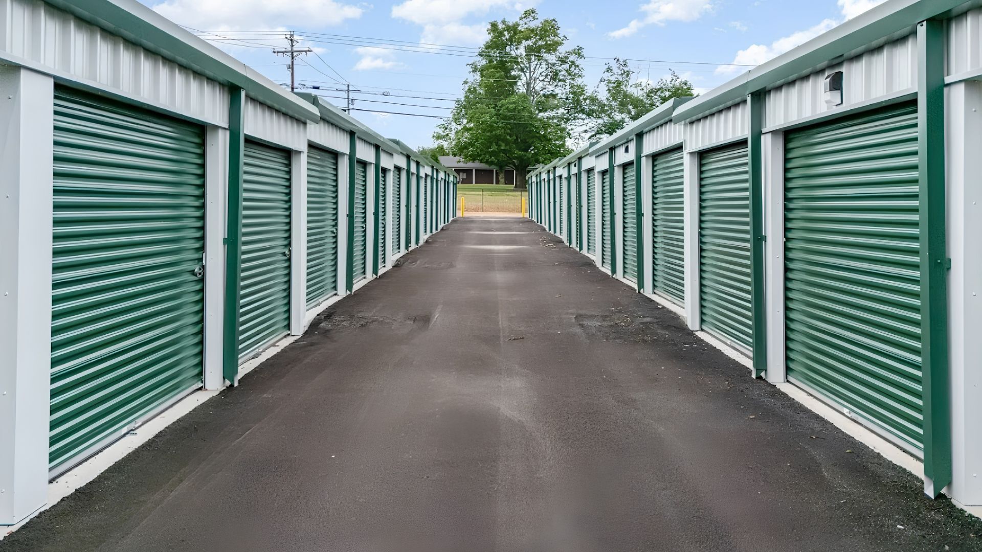 Drive-up self storage units at Hardin County Storage with green roll-up doors and paved access lanes. Drive-up self storage units at Hardin County Storage with green roll-up doors and paved access lanes.