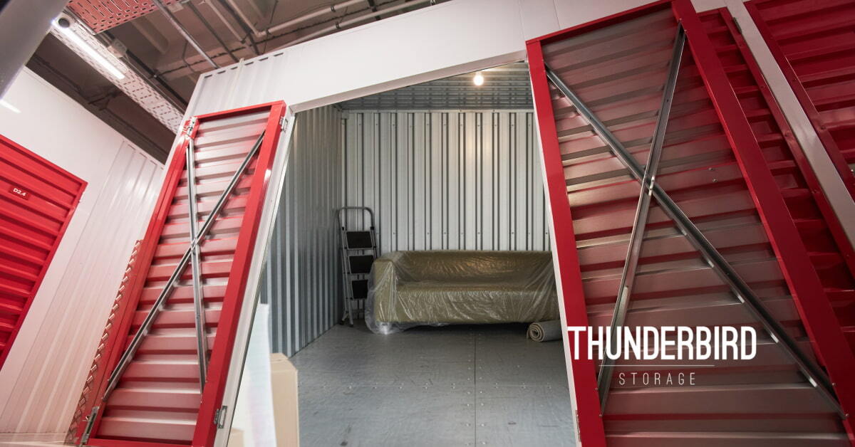 A plastic-wrapped couch securely stored inside a clean, indoor Thunderbird Storage unit with open red doors in Cedar City. A plastic-wrapped couch securely stored inside a clean, indoor Thunderbird Storage unit with open red doors in Cedar City.