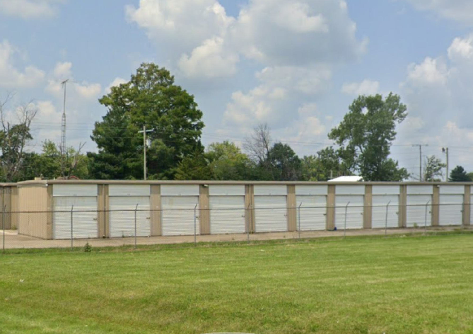 Fenced row of drive-up storage units with roll-up doors in Centralia.