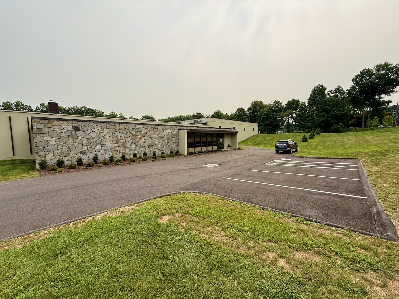 The office entrance and freshly striped parking lot at Southbury Self Storage in Southbury CT