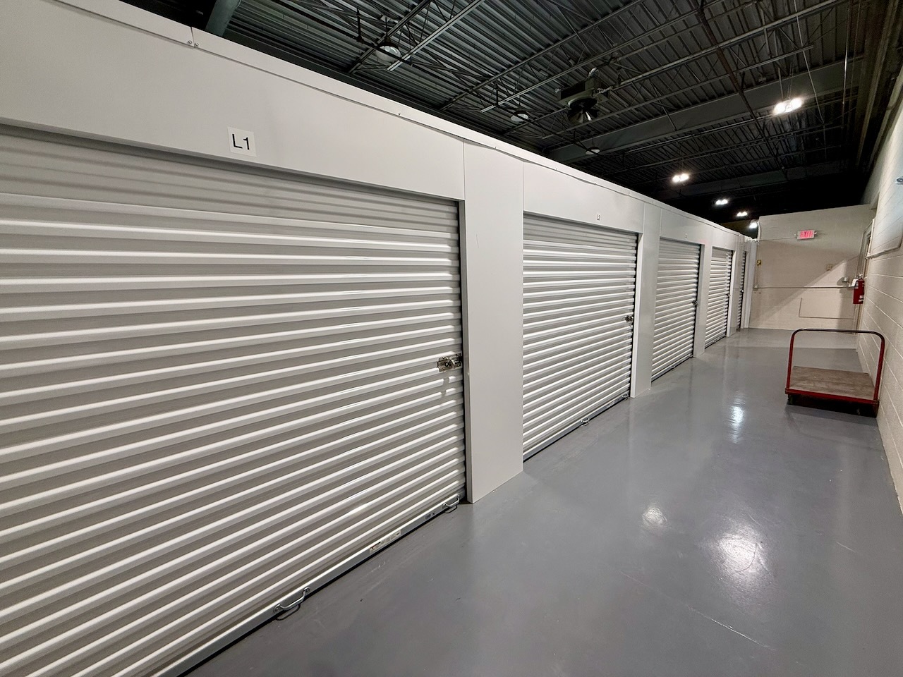 Clean interior hallway lined with storage units at Southbury Self Storage