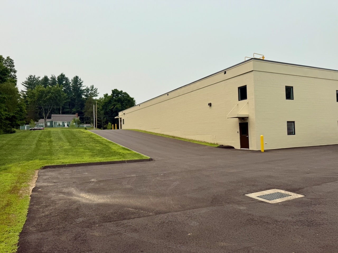 The paved driveway ramp climbing to the second level entrance of Building 2 at Southbury Self Storage