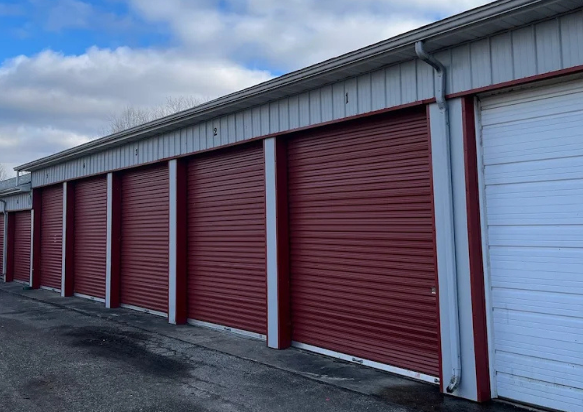 Close view of red roll-up doors on drive-up storage units in Knox.