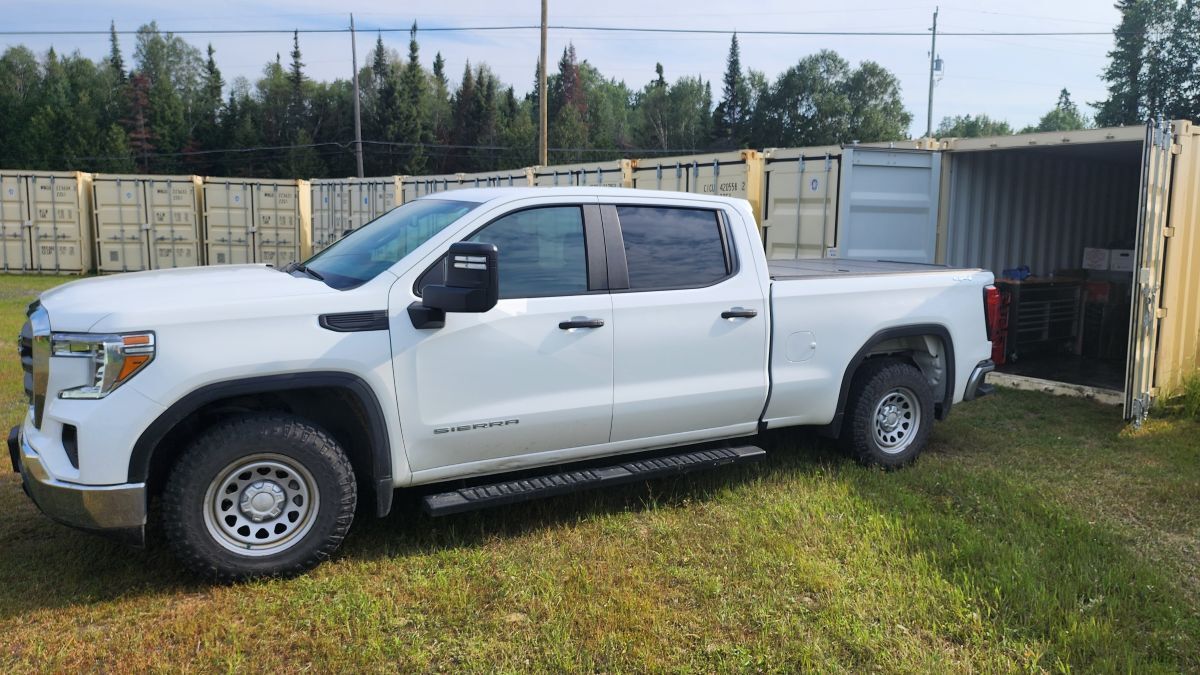 Pickup truck accessing secure drive-up self storage containers at DAM Reliable Storage in Kenora, Ontario.