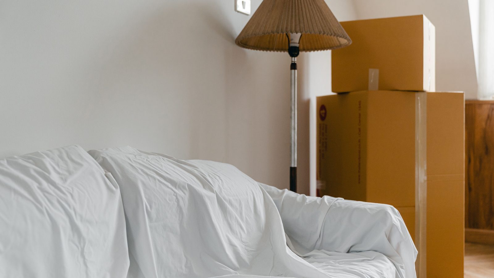 Moving boxes and covered furniture while choosing a storage unit size in Charlevoix