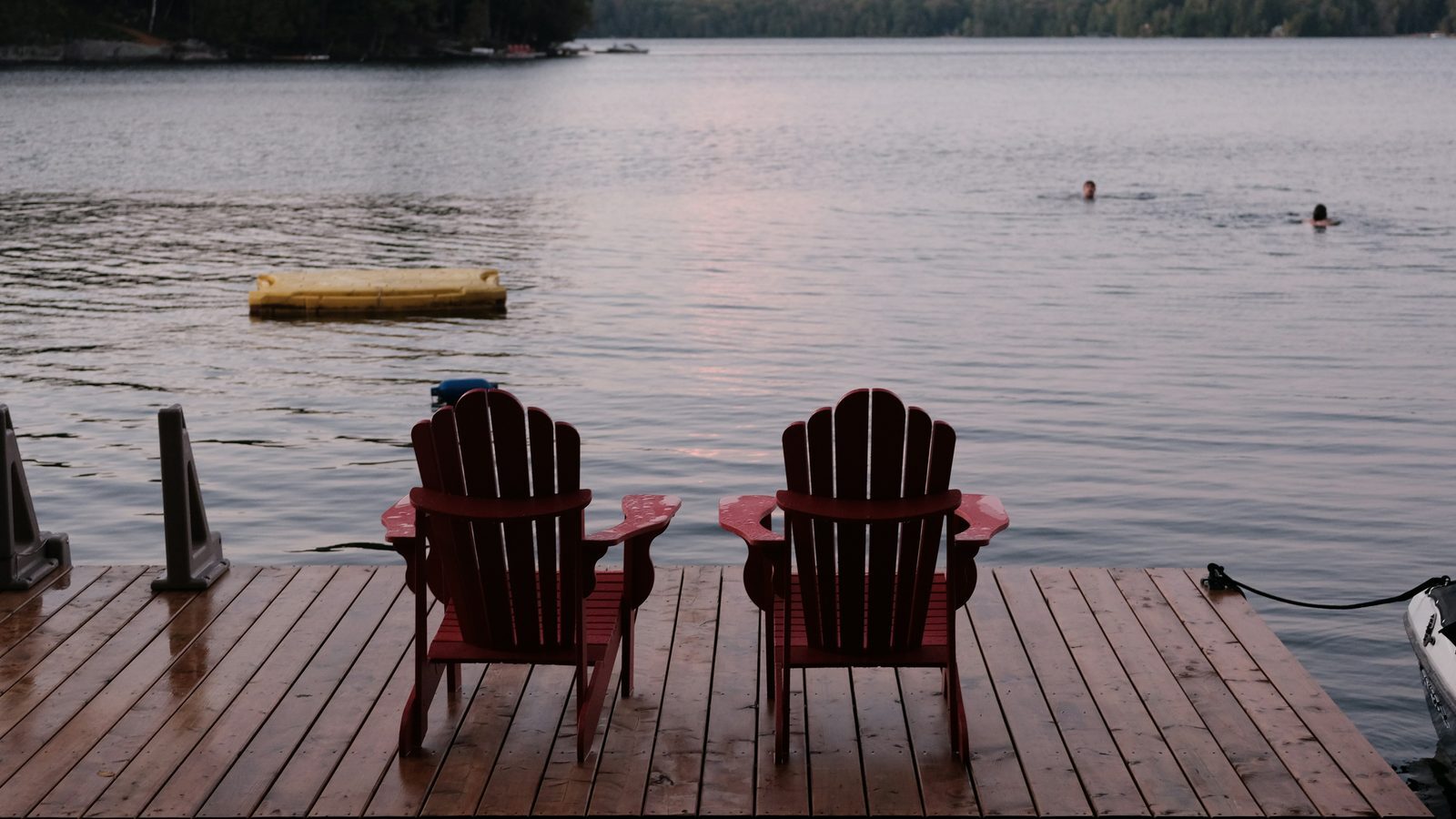 Adirondack chairs on a lakeside dock representing seasonal cottage storage in Northern Michigan Adirondack chairs on a lakeside dock representing seasonal cottage storage in Northern Michigan