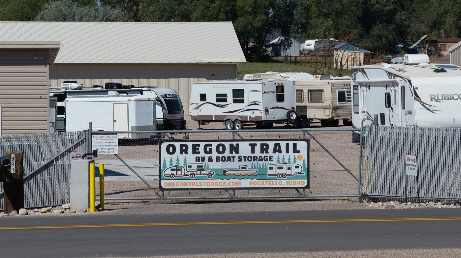 Oregon Trail Storage entrance sign and coded gate Entrance to Oregon Trail RV and Boat Storage from Dekay Road, showing the facility sign and coded access gate.