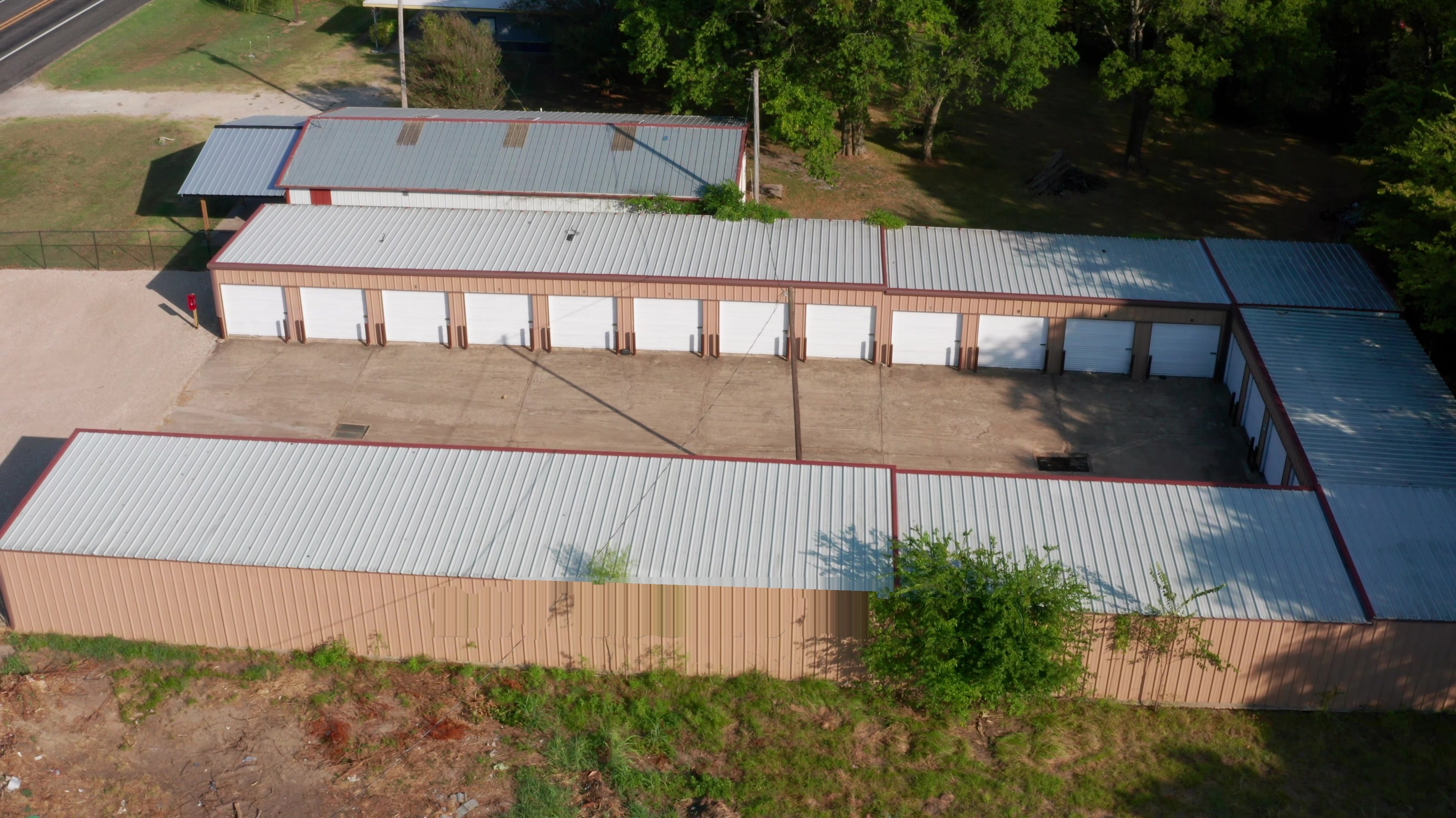 Aerial view of the horseshoe shaped storage building at To the Point Storage in Point, Texas, with drive up units on three sides of a concrete courtyard Aerial view of the horseshoe shaped storage building at To the Point Storage in Point, Texas, with drive up units on three sides of a concrete courtyard