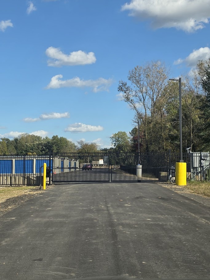 Entrance gate and paved drive at Handy Storage.