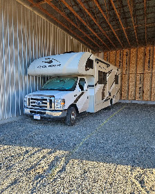 Class C motorhome parked in a covered RV storage space at Elite Storage in Rexburg, Idaho