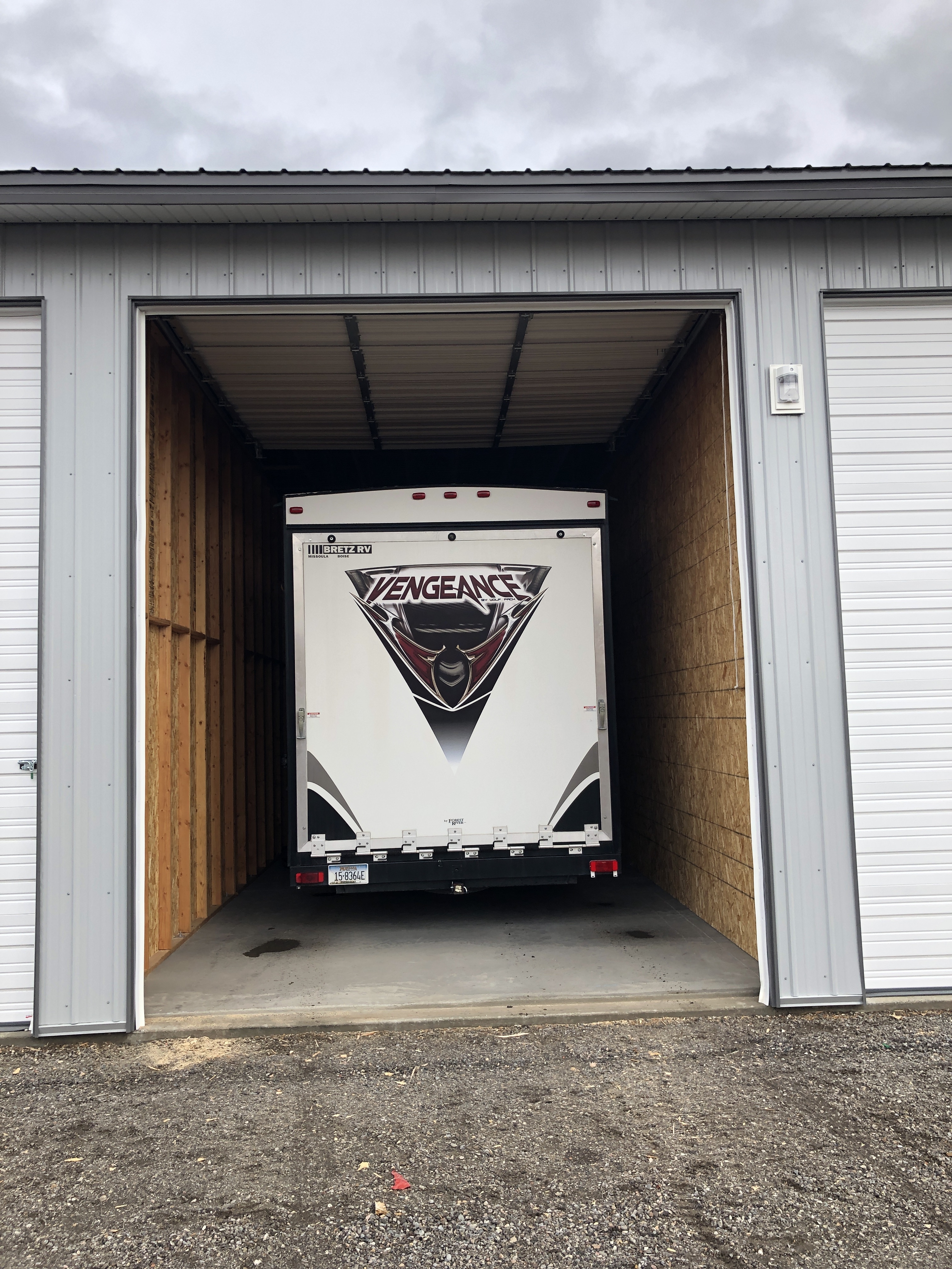 Rear of an RV stored in a drive-through storage unit at Elite Storage in Rexburg, Idaho