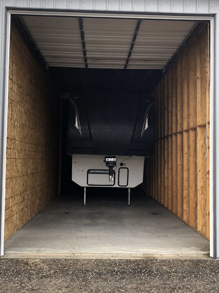 Front of an RV stored in a drive-through storage unit with a door on each end at Elite Storage in Rexburg, Idaho