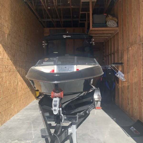 Boat on a trailer stored inside an enclosed storage unit at Elite Storage in Rexburg, Idaho