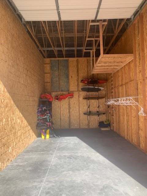 Enclosed unit with boat gear racks and an overhead loft at Elite Storage in Rexburg, Idaho