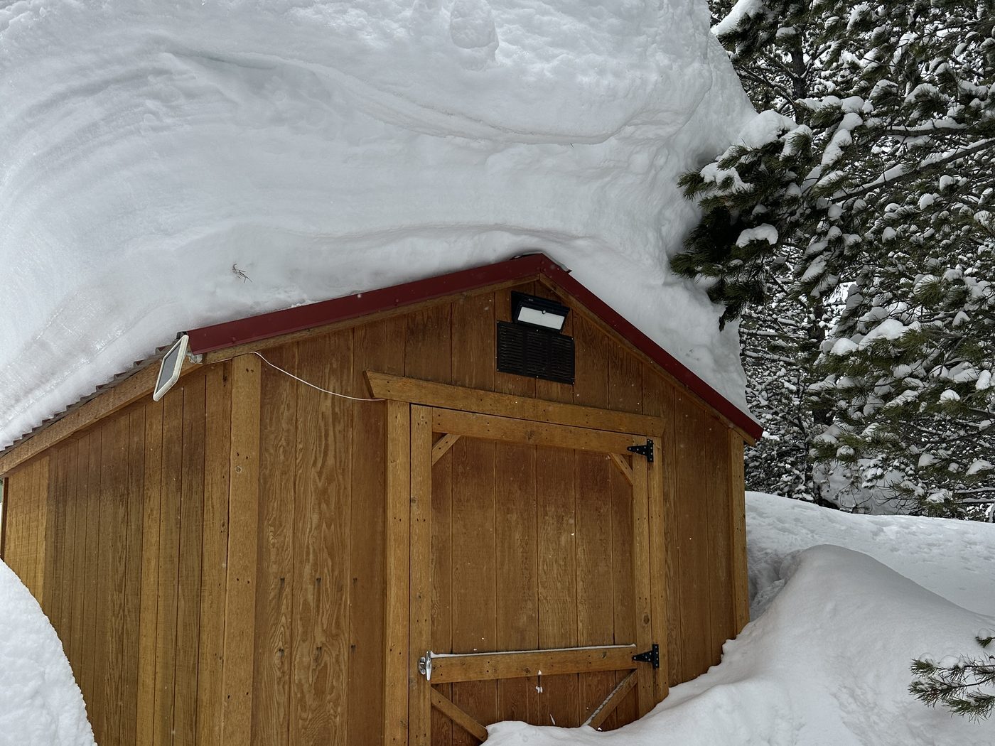 Deep snow on a shed roof in Island Park, Idaho Deep snow piled on a shed roof in Island Park, Idaho