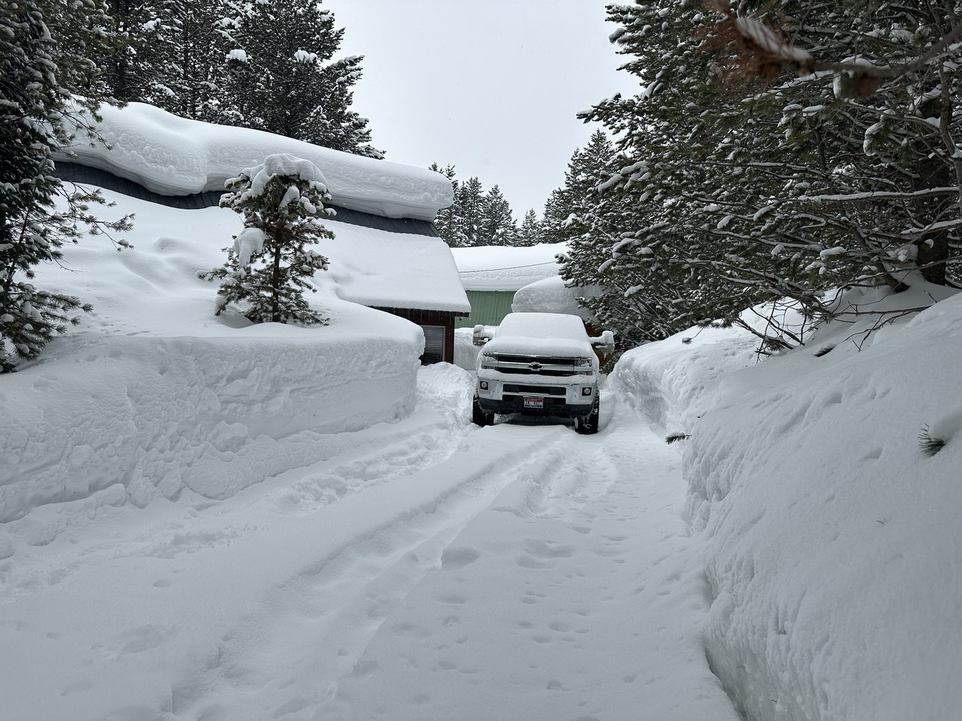 Truck in a snow-covered driveway in Island Park, Idaho Snow-covered truck in a driveway after heavy snowfall in Island Park, Idaho