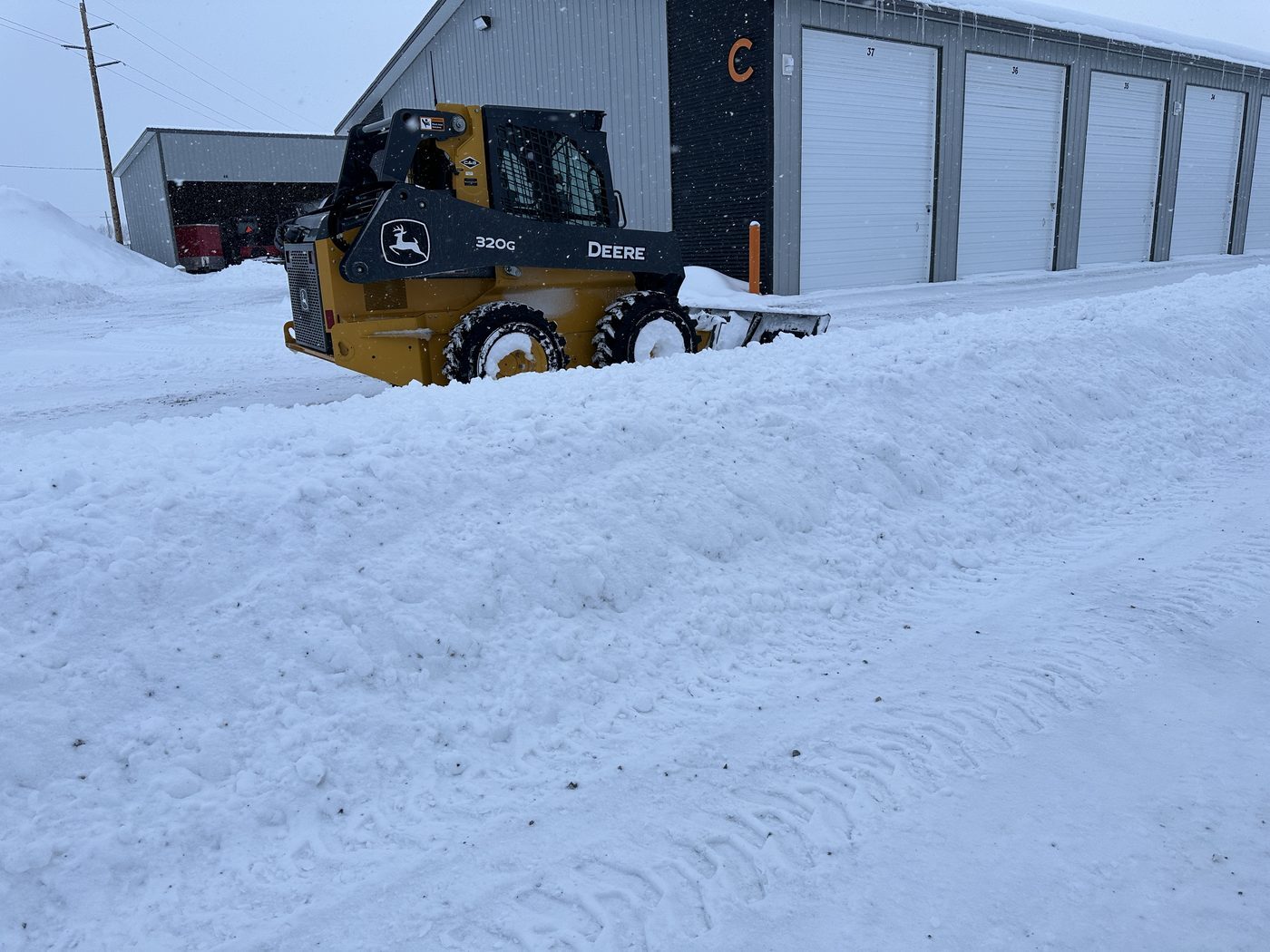 Skid steer clearing snow at Elite Storage in Rexburg, Idaho Skid steer clearing snow from the aisles at Elite Storage in Rexburg, Idaho