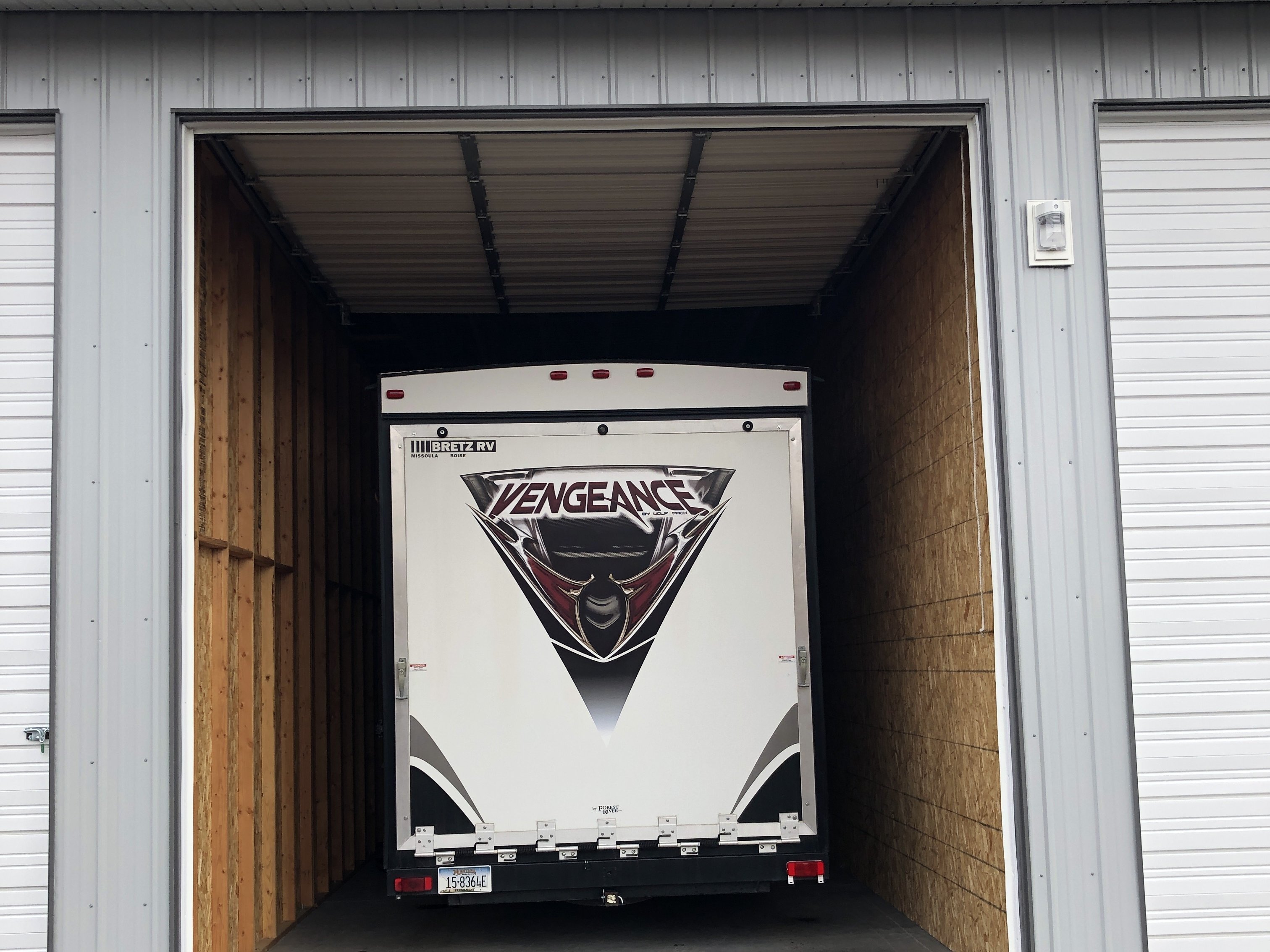 Rear of an RV stored in a drive-through storage unit at Elite Storage in Rexburg, Idaho