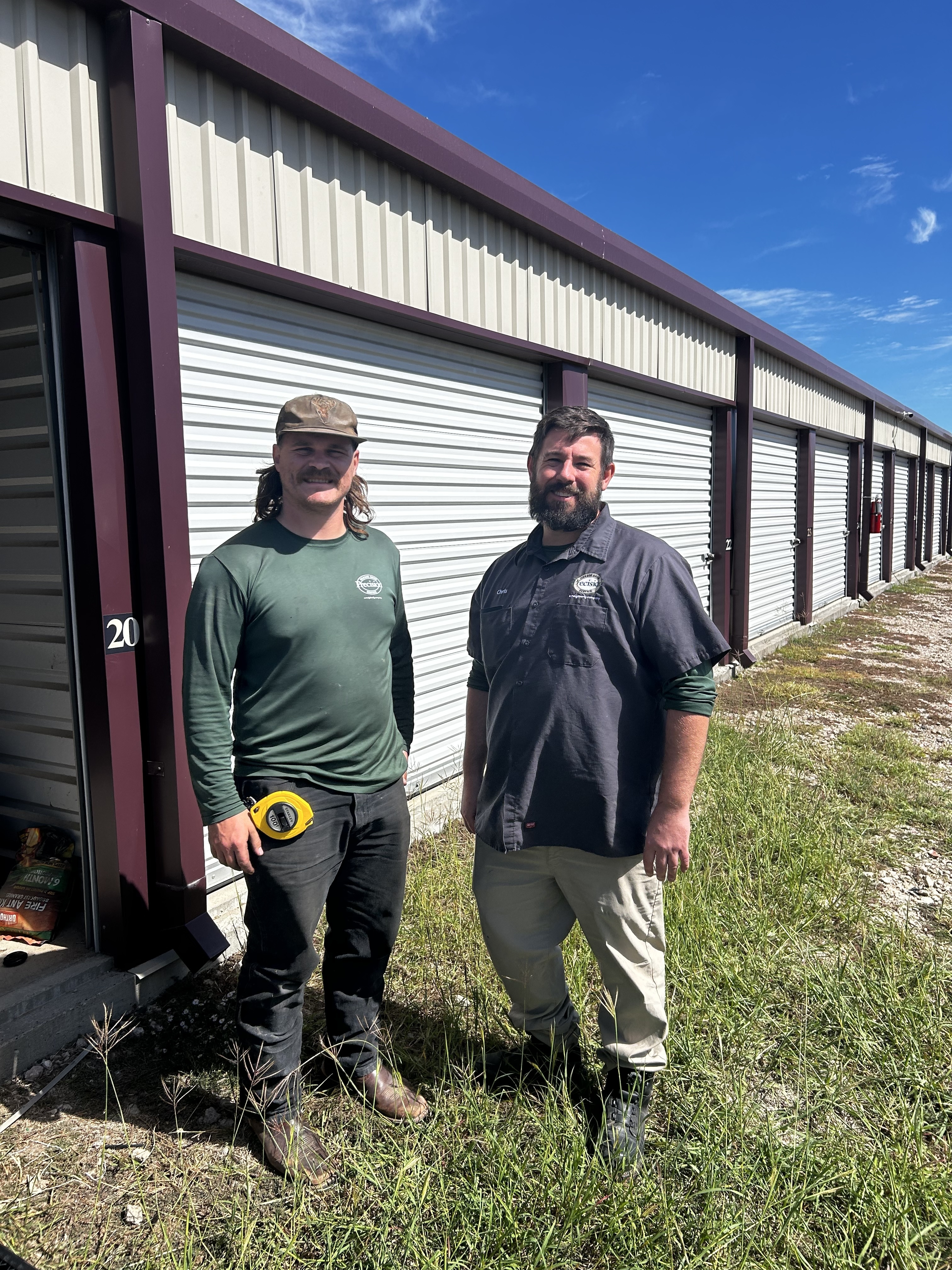 Two garage door experts in front of Howdy Storage Unit Two garage door experts in front of Howdy Storage Unit