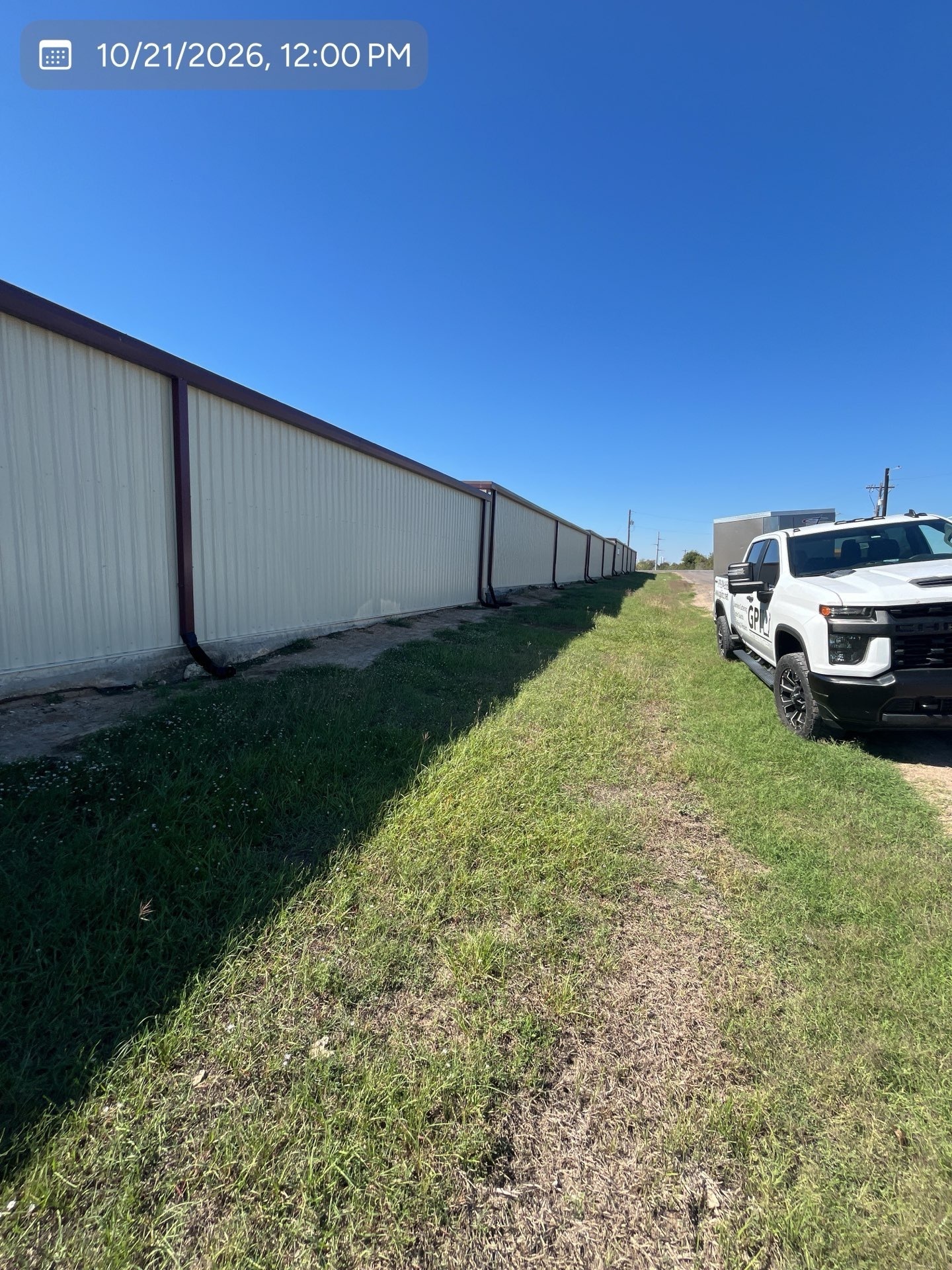 back of Howdy Storage building with newly installed downspouts and GPI truck visible